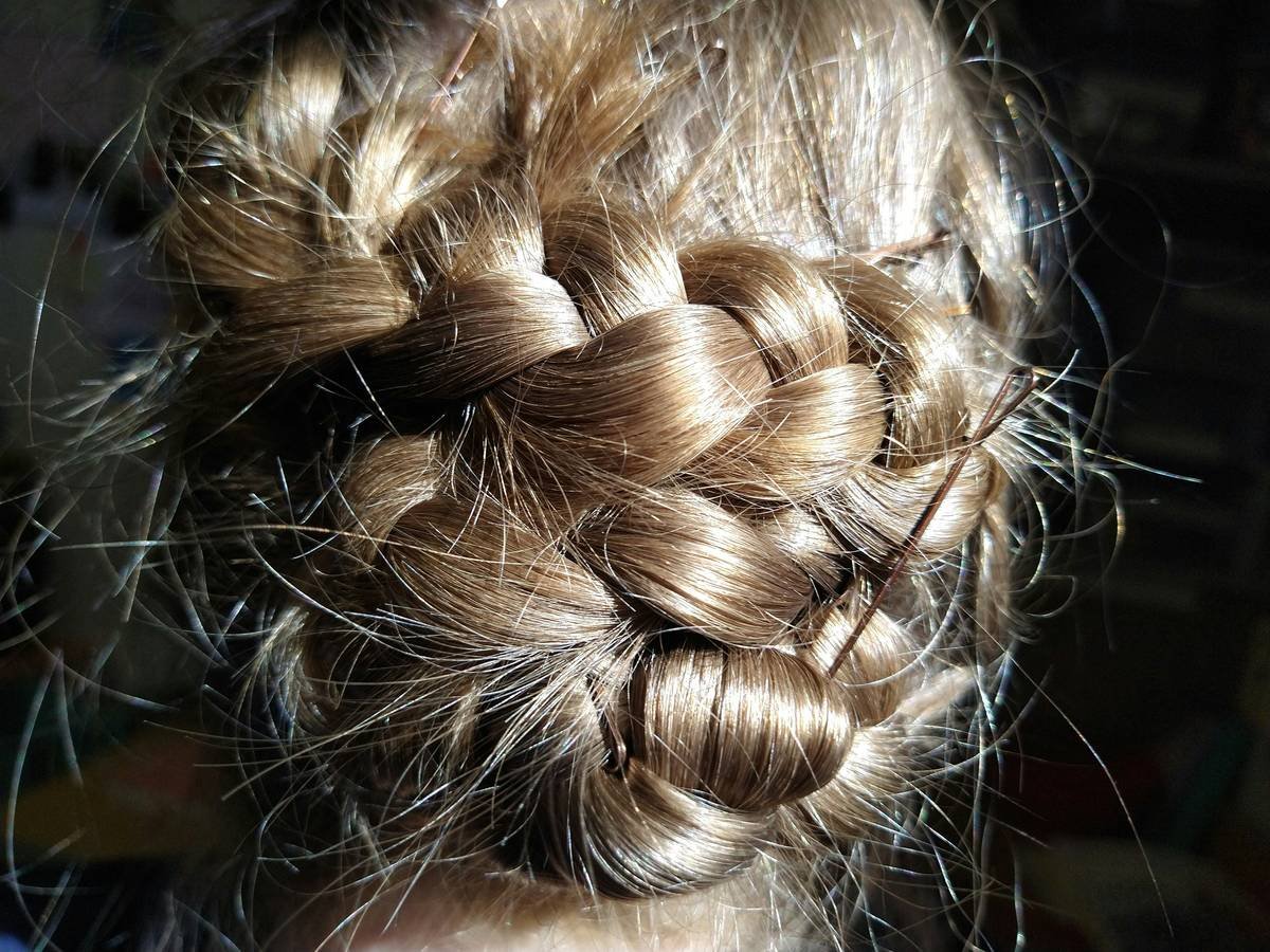 Close-up of hair pins securing styled hair after heat protectant application